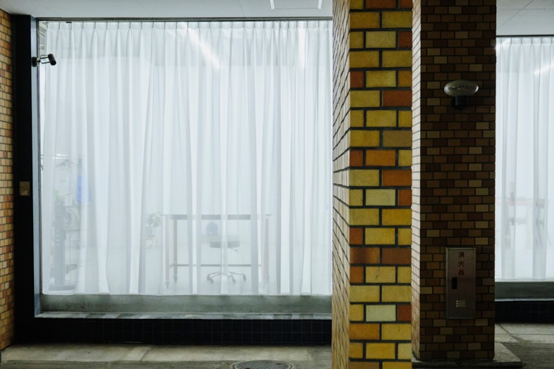 STUDIO ZYX｜外観のヴィンテージ感とカーテン越しの室内を捉えた構図