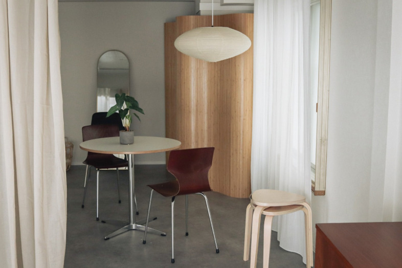 OLUE STUDIO｜丸テーブルを囲む椅子とスツール、木質パネルが彩るダイニング風景