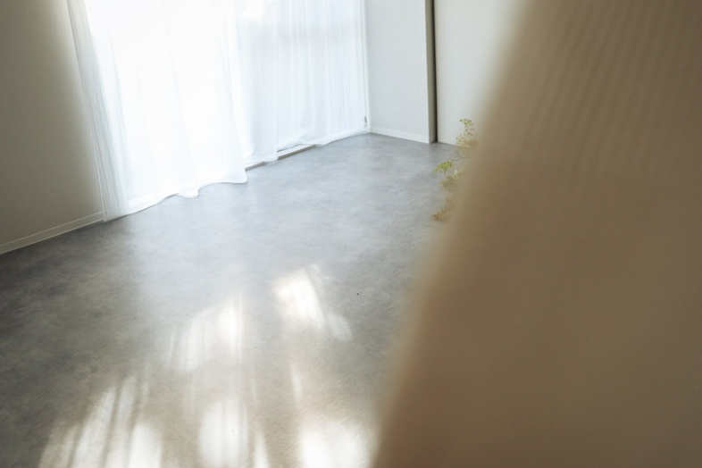 OLUE STUDIO｜窓辺いっぱいに広がる自然光と影、抜け感あるコンクリート風床の空間